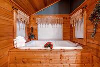 Soak in large jacuzzi tub in this honeymoon cabin